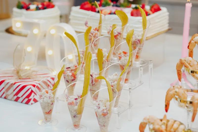 Individual appetizer cups with plantain chips on a styled display