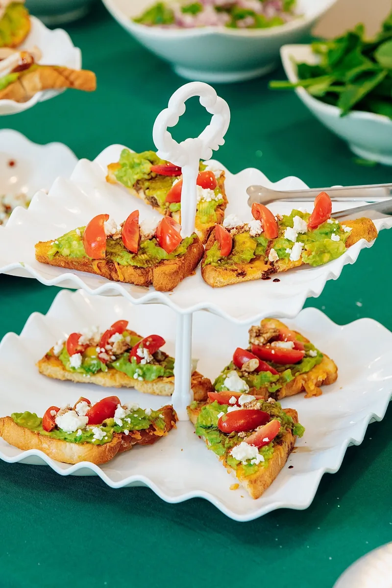 Tiered white stand of topped crostini appetizers