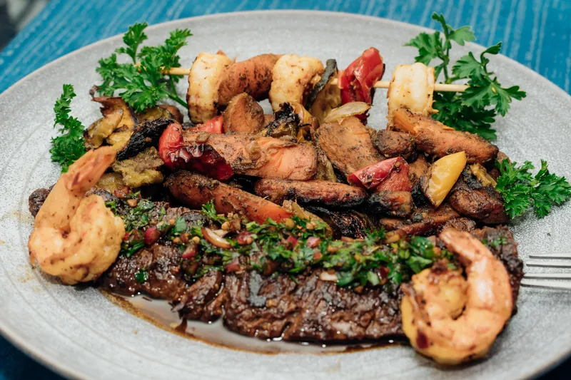 Steak with shrimp and roasted vegetables on a plate