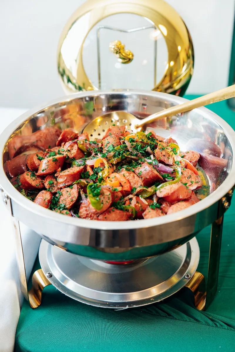 Sausage and peppers in a gold-toned chafing dish